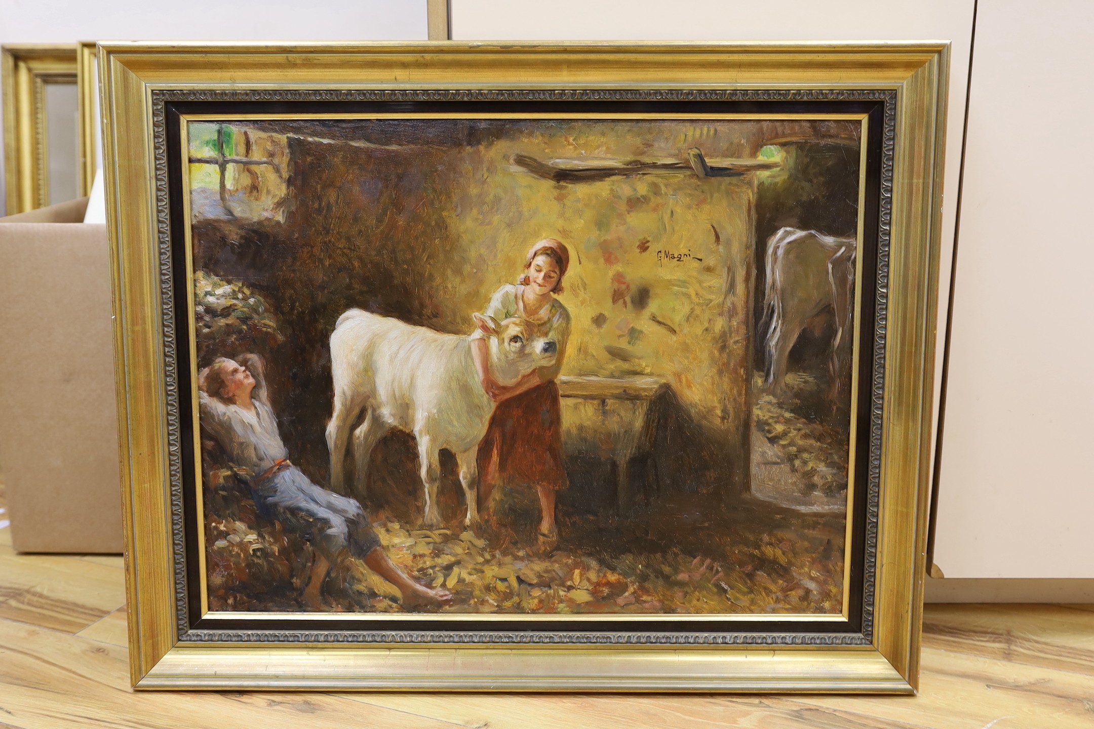 Giuseppe Magni (1869-1956), oil on canvas, farmyard interior with figures and cattle, signed, 49 x 64cm